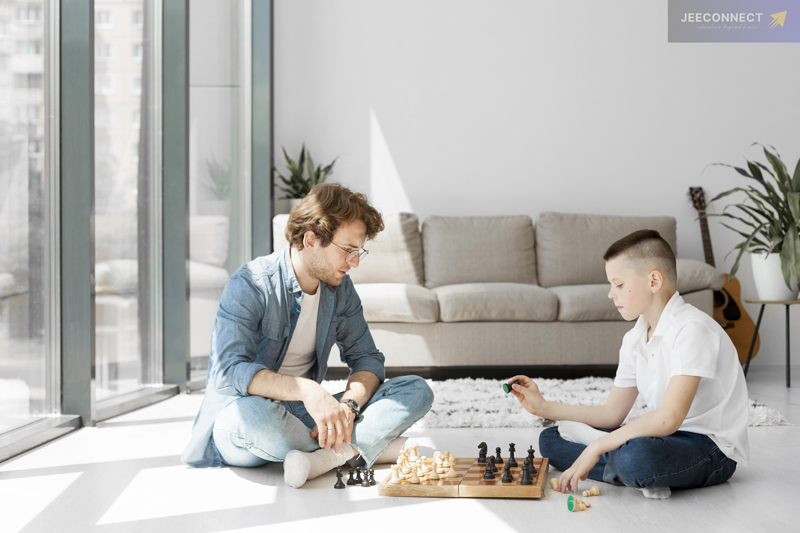 tutor showing young boy how to play chess